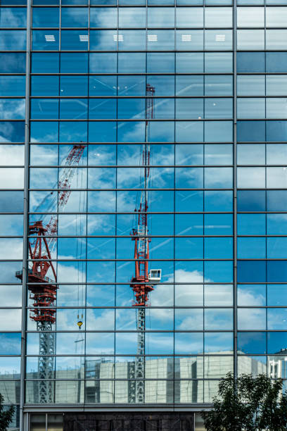 Construction site of Kobe city reflected in building's mirror, Japan