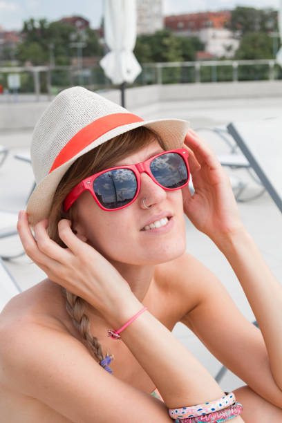 istock Cute young woman enjoying summertime at the poolside. 1209846230