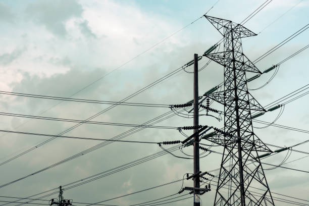 istock Electricity pole against blue sky clouds in dawn time 1209846471