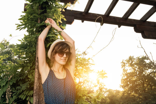 istock Cute young woman posing outdoors in summertime sunlight. 1209846595