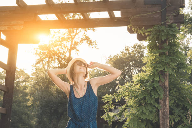 istock Cute young woman posing outdoors in summertime sunlight. 1209846726