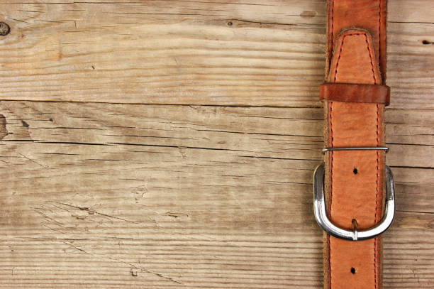 istock vintage belt buckle on a old wooden board 1209846893