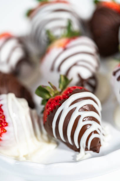 istock White and dark chocolate dipped strawberries on a white cake stand. 1209846959