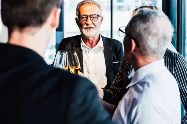 Photo of Multiethnic group businesspeople holding aperitif champagne, Business people party celebration success after meeting. Business and celebration concept.