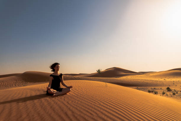 istock Yoga pose in the desert before sunset 1209847216