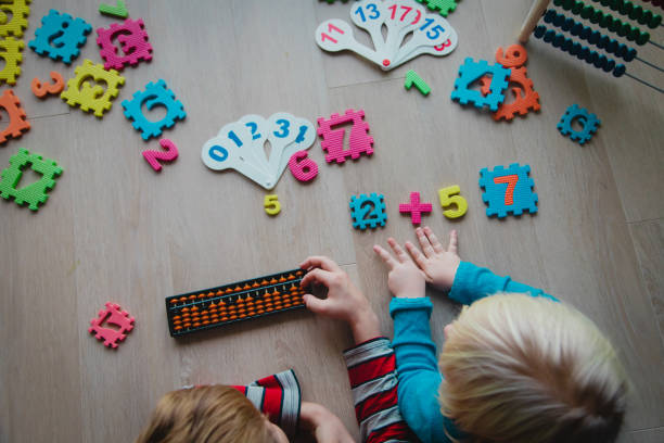 istock kids learning numbers, boy and girl counting on abacus 1209847249