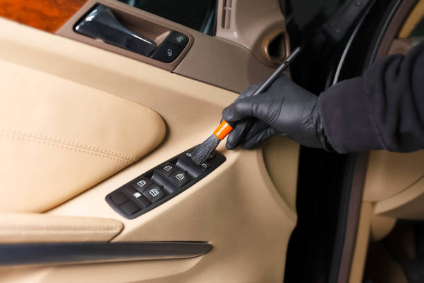 istock Detailing master cleans car interior with a brush 1209852217
