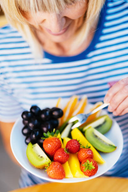 istock Attractive senior woman with fruit lunch 1209853366