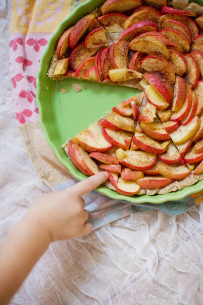 istock The little kid's hand touches an apple pie 1209853369