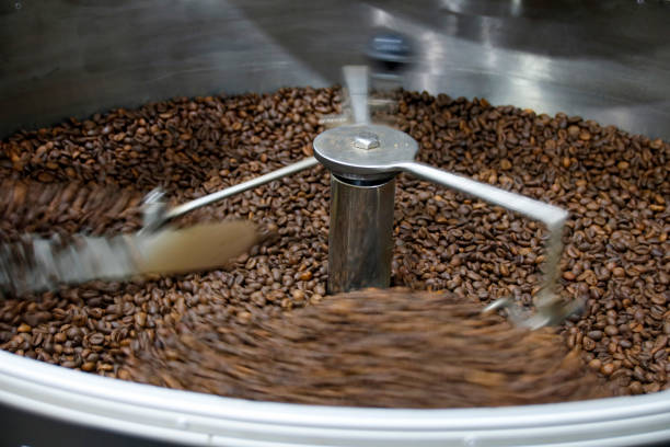 istock The freshly roasted coffee beans from a large coffee roaster being poured into the cooling cylinder. Motion blur on the beans. 1209855860