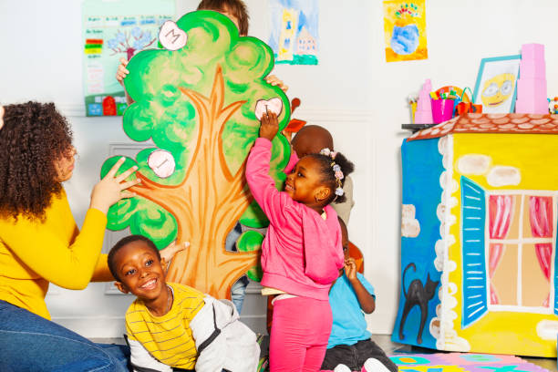 istock Kids group putting first letters of their name 1209856763
