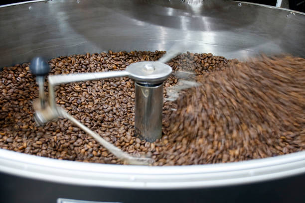 istock The freshly roasted coffee beans from a large coffee roaster being poured into the cooling cylinder. Motion blur on the beans. 1209856933