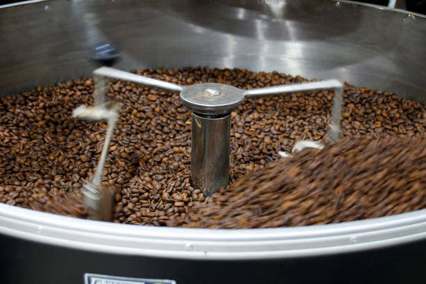 istock The freshly roasted coffee beans from a large coffee roaster being poured into the cooling cylinder. Motion blur on the beans. 1209857246
