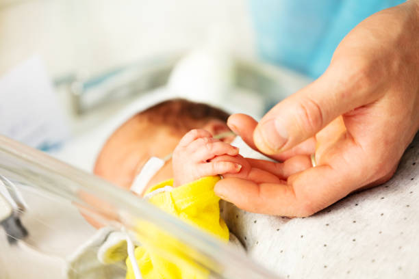 istock Fathers hand close-up with sick newborn boy 1209858346