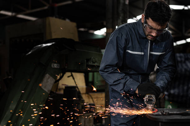 istock Good factory technicians are grinding iron at the shop causing sparks. 1209858445