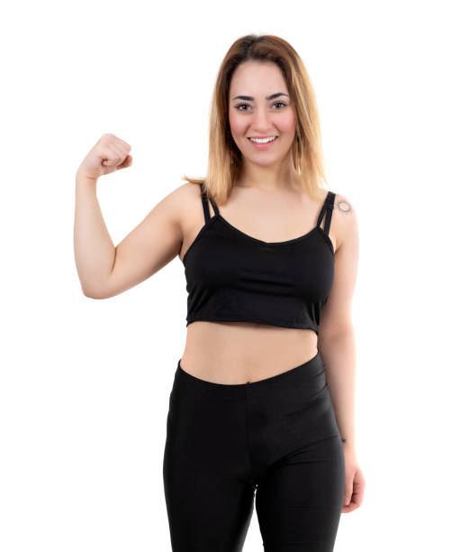 istock Powerful young woman in black clothes studio shoot on white background 1209859681
