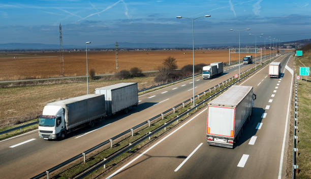istock Convoys of transportation trucks passing on a highway 1209861394