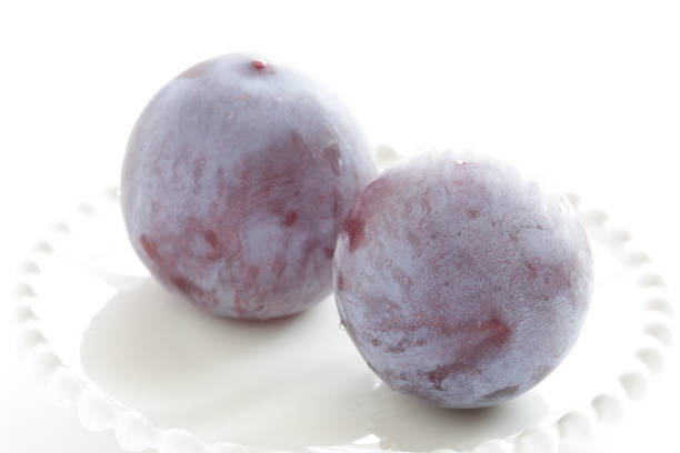istock Freshness prune from japan on white dish with copy space 1209861613