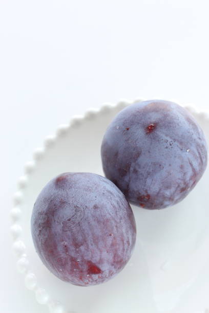 istock Freshness prune from japan on white dish with copy space 1209861671