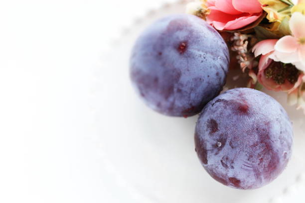 istock Freshness prune from japan on white dish with copy space 1209861697