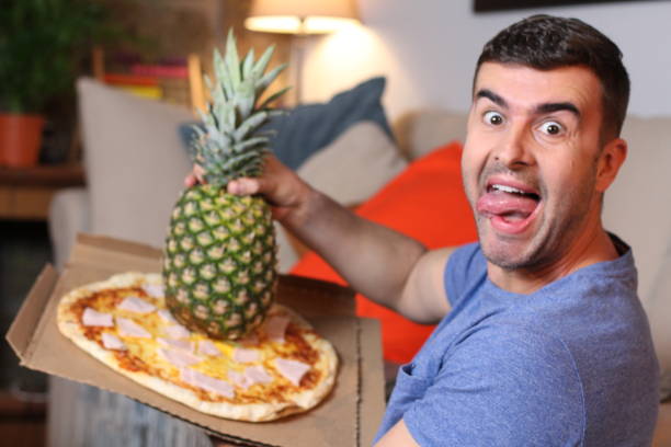 istock Wild man mixing a whole pineapple with pizza 1209862349