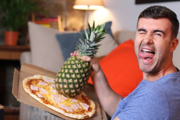 istock Man in love with Hawaiian pizza 1209862379