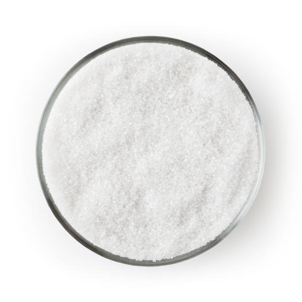 istock Granulated sugar in glass bowl isolated on white background with clipping path 1209862865