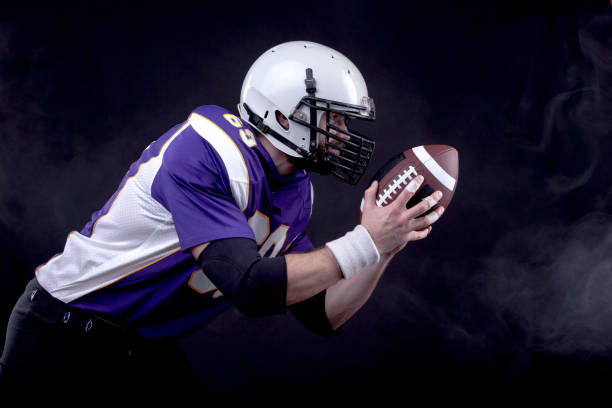 istock American Footballer in action 1209863115