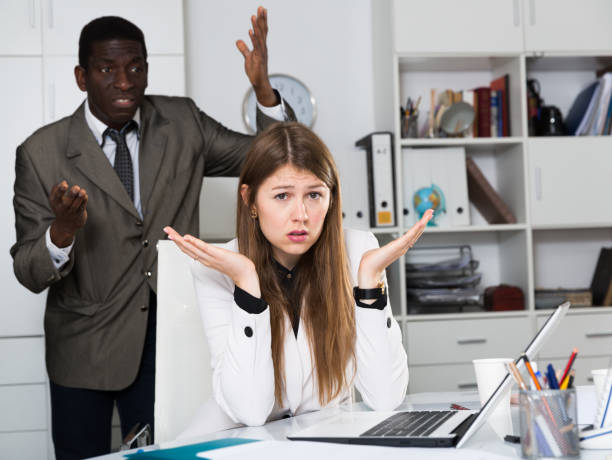 istock Angry male boss screaming  to young female manager during working 1209863191