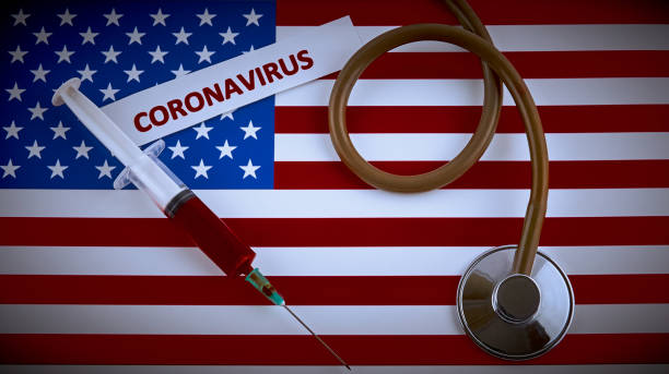 istock Stethoscope and syringe on USA flag with coronavirus label 1209864257