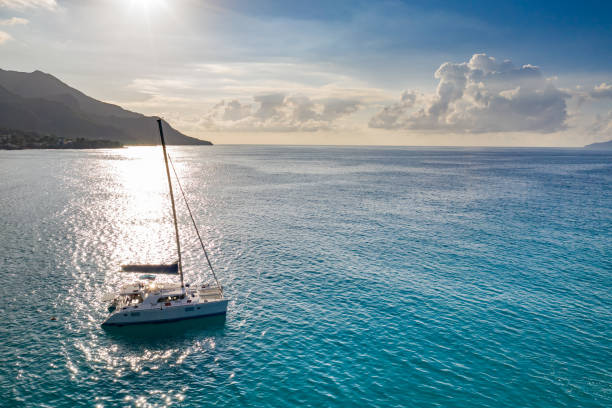 istock Sailboat in the ocean at sunset. 1209864314