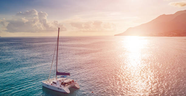 istock Sailboat in the ocean at sunset. 1209864379