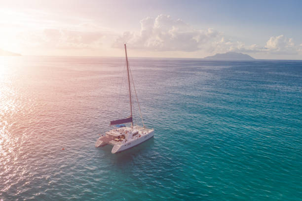 istock Sailboat in the ocean at sunset. 1209864392