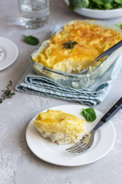 istock Potato casserole with fish and cheese on a light grey background. 1209865481