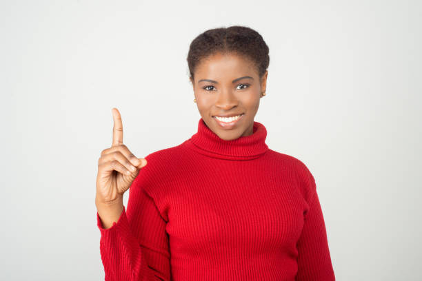 istock Beautiful smiling woman pointing up with finger 1209865751