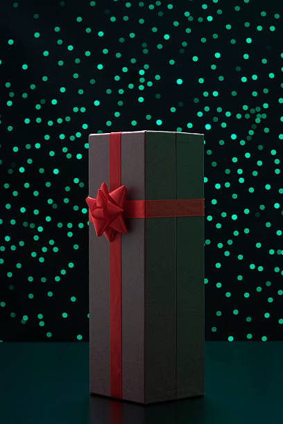 istock Elegant gift box with red ribbon against green illumination background 120986621
