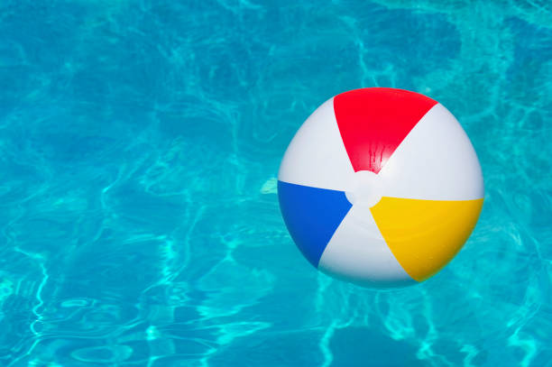 istock Colorful inflatable ball floating in swimming pool 1209866630