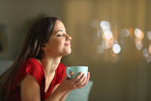 istock Relaxed woman resting holding coffee mug at night 1209866855