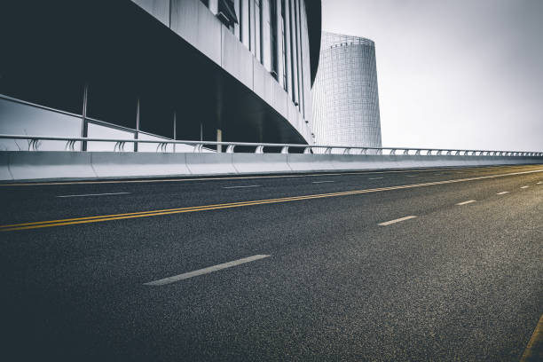 istock Divided highway passing through city buildings, blue nostalgia high contrast 1209867439