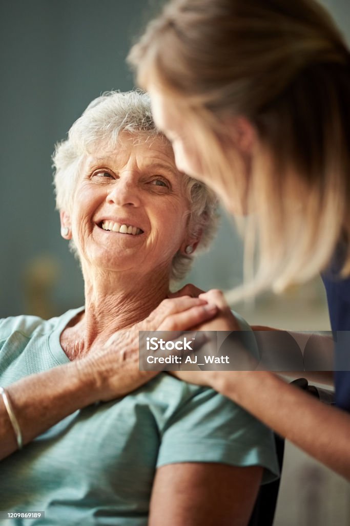 I'm so grateful for you help and care Shot of a senior woman patient sitting in a wheelchair at rehab with a supportive caregiver Senior Adult Stock Photo
