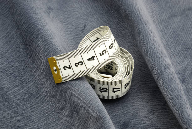 istock measure tape on fabric background 1209870937