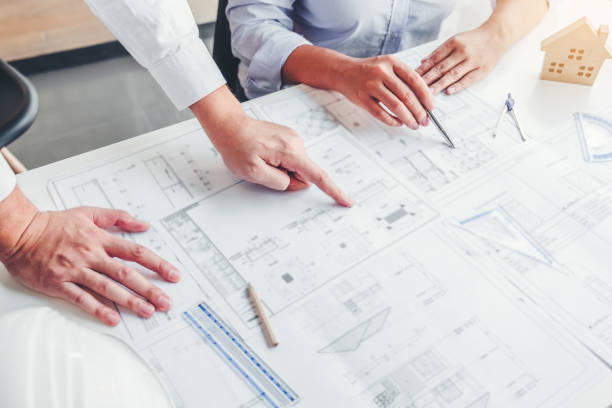 istock Team Engineer drawing graphic planning and meeting for architectural project on workplace 1209871114