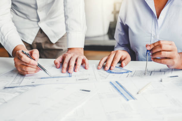 istock Team Engineer drawing graphic planning and meeting for architectural project on workplace 1209871161