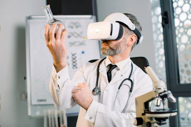 istock Mature man scientist in modern bright lab, using virtual reality glasses for research, looking at the glass flask with new substance or drug. Vr Goggles, medicine, science concept 1209871206