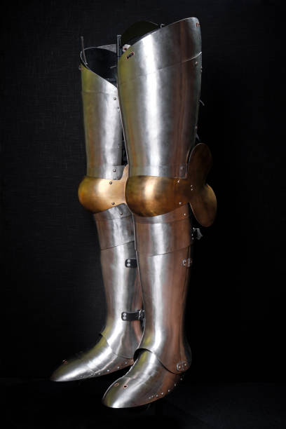 istock Knight armor for legs on a black. 1209872133