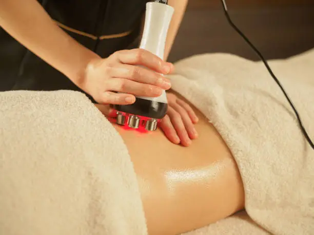 Japanese woman undergoing back and waist treatment with hyper knife at beauty salon