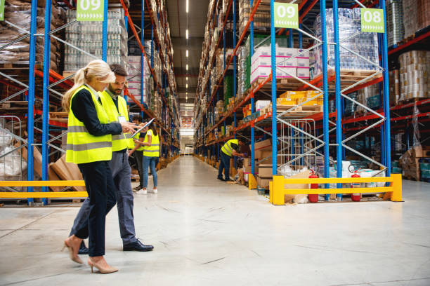 istock Managers in Warehouse discuss about business 1209872829