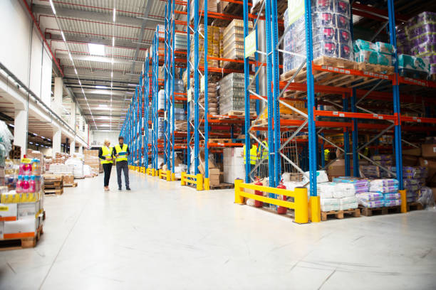 istock Managers in Warehouse discuss about business 1209872830