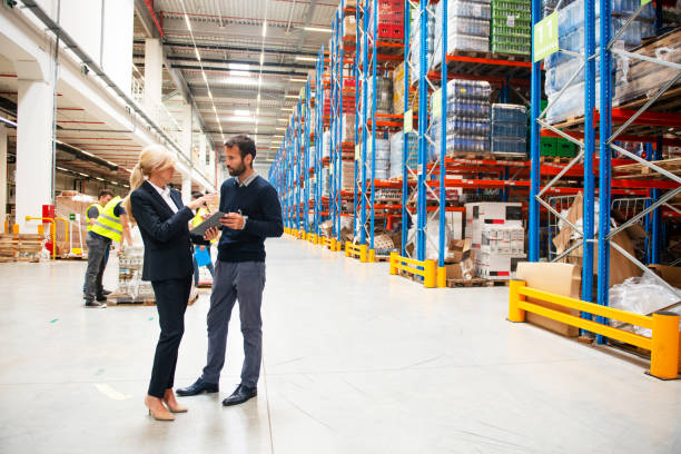 istock Managers in Warehouse discuss about business 1209872838