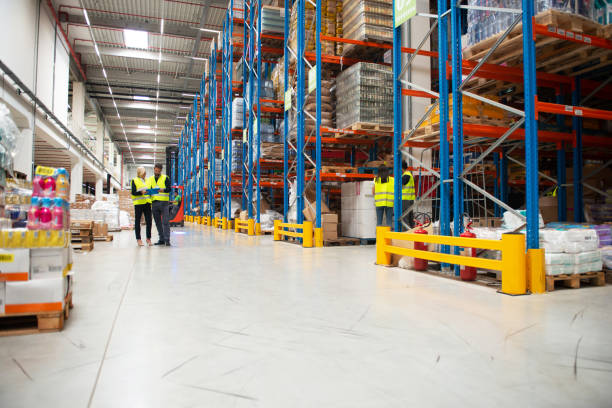 istock Managers in Warehouse discuss about business 1209872997
